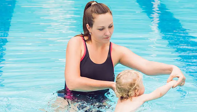 a photo of mama and baby swimming